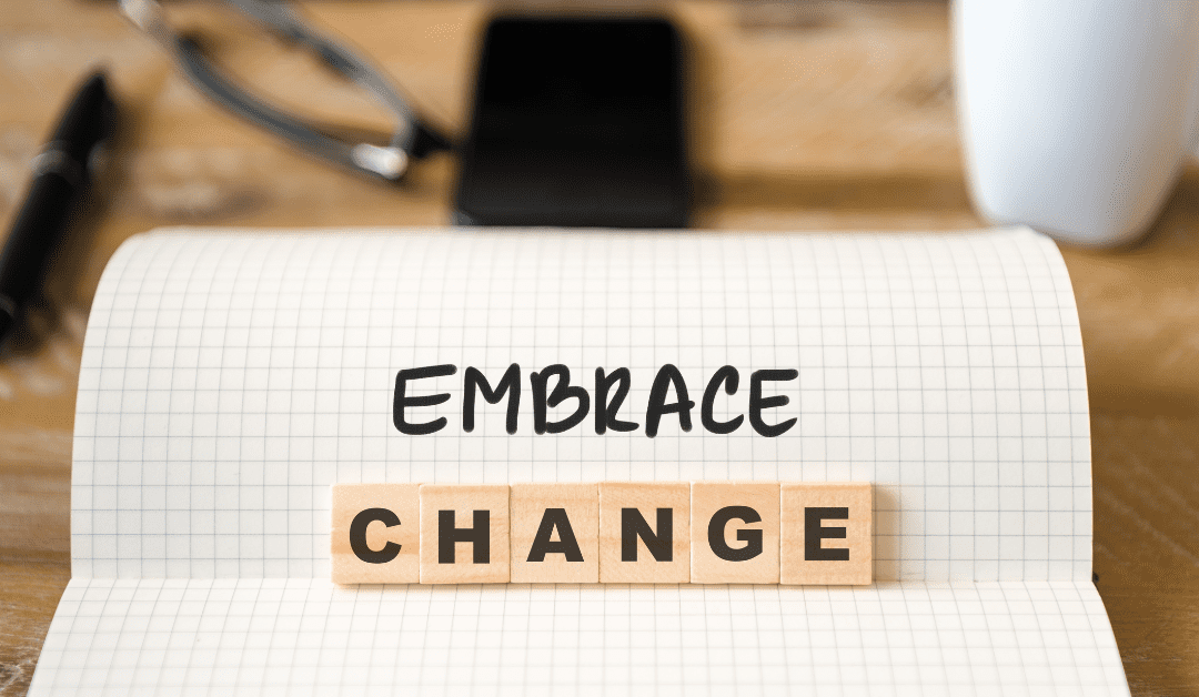 scrabble tiles on a desk that say "embrace change"